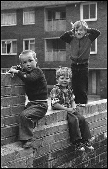three boys on a wall